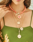 Model wearing various forever coin pendants