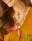 Model wearing various pendants featuring bees, scarabs, flowers, and butterflies