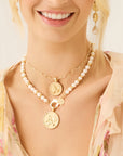 Model wearing the joy camellia coin, joy chickadee coin, and tea party earrings