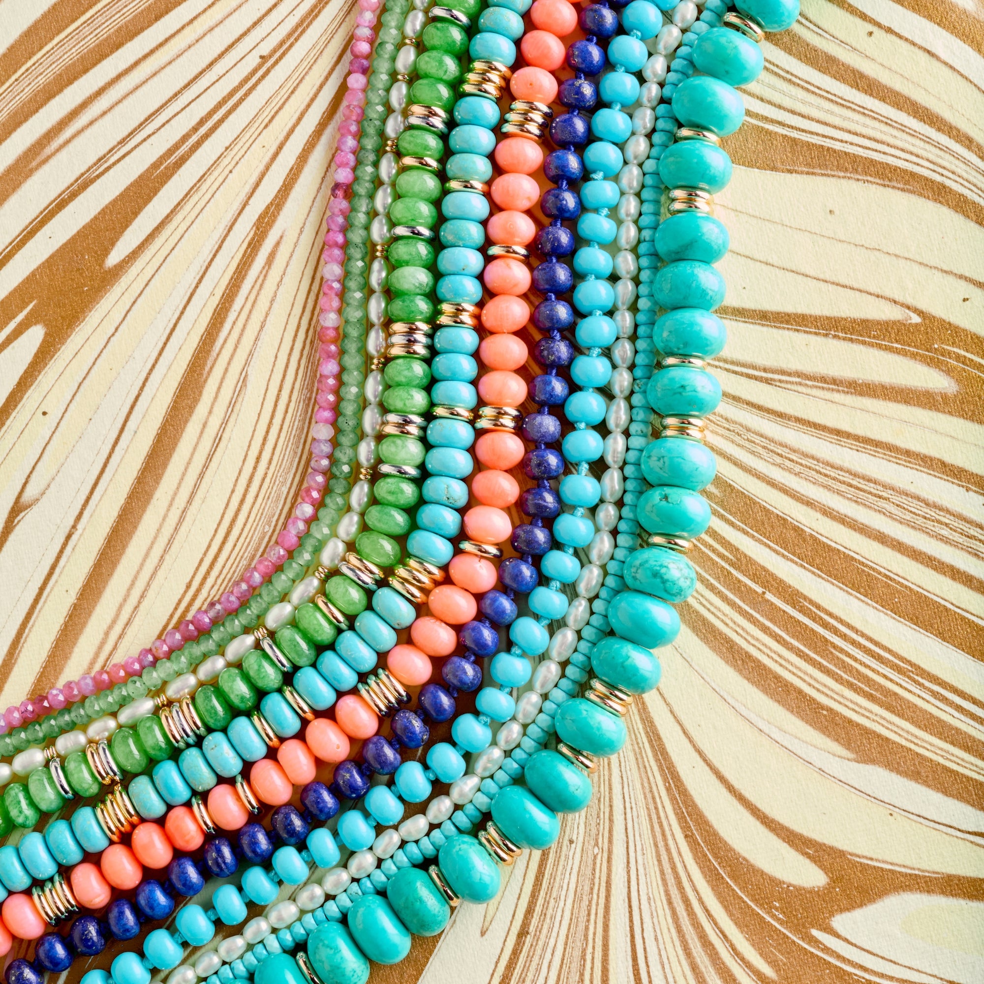 Stylized shot showing various sizes and colors of beaded necklaces