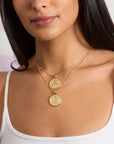 Model wearing the forever 2026 coins to show the front and back