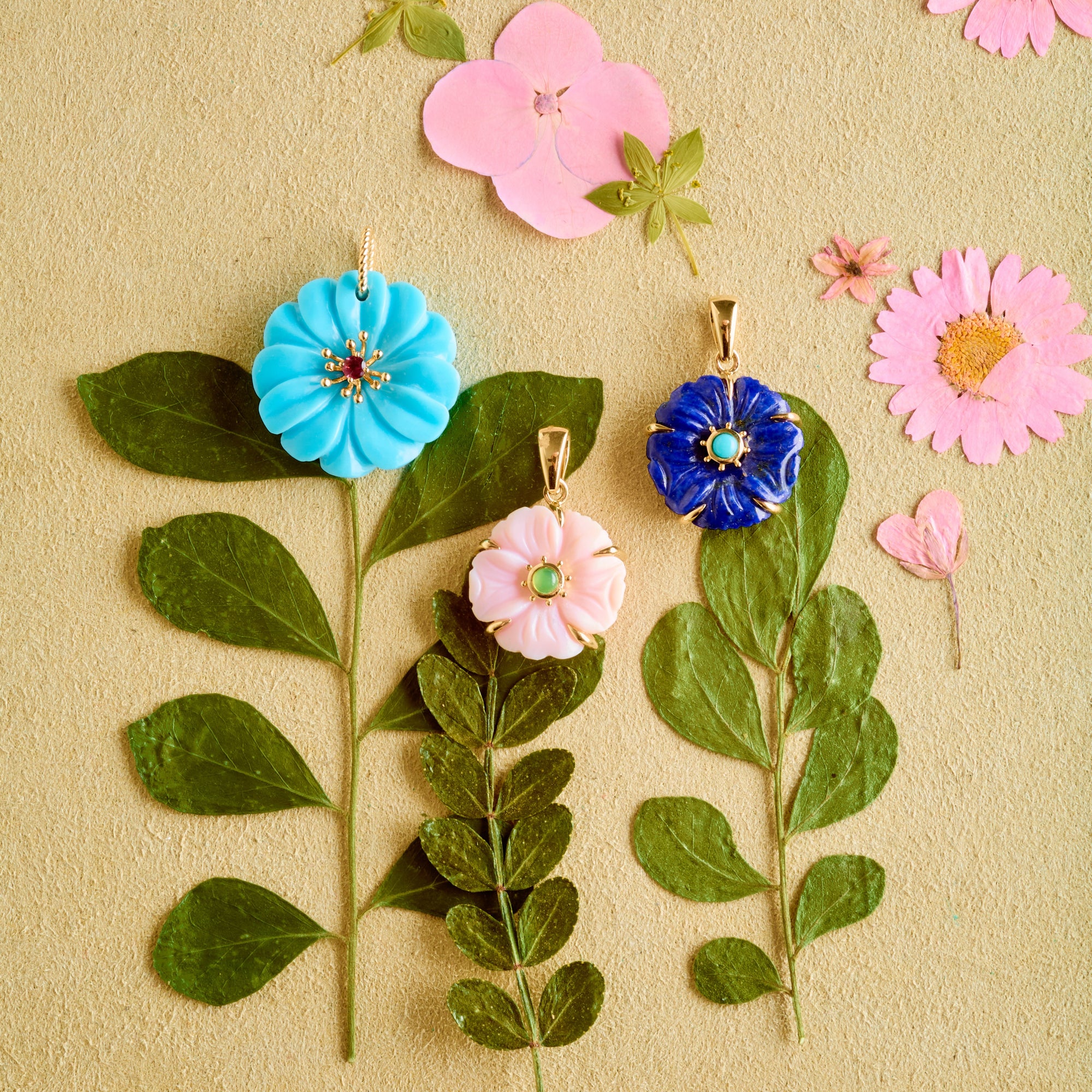 Stylized shot of carved flower pendants with dried flowers and stems