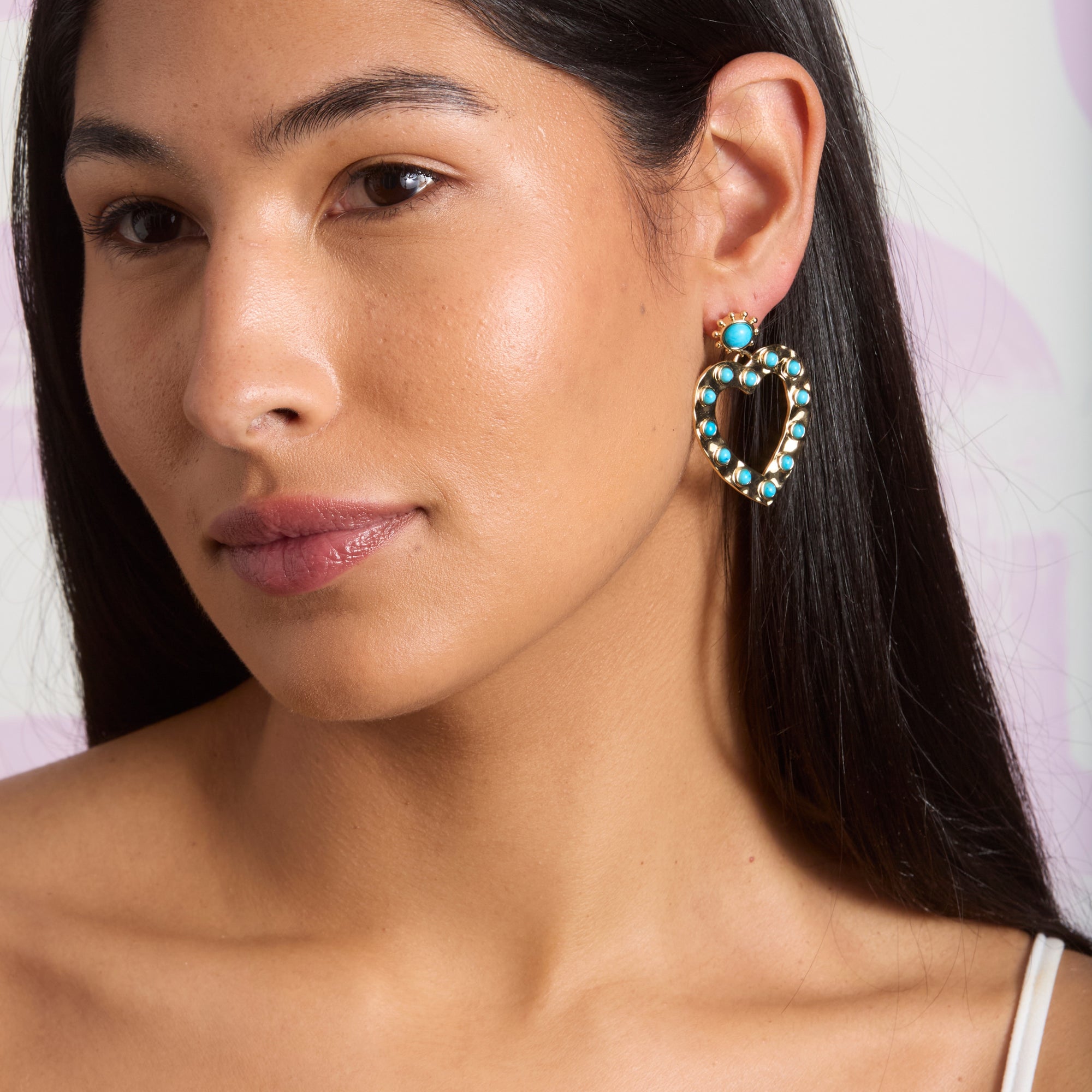Model wearing the love in the sun earrings in turquoise