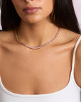 Model wearing the made from love tennis necklace in pink