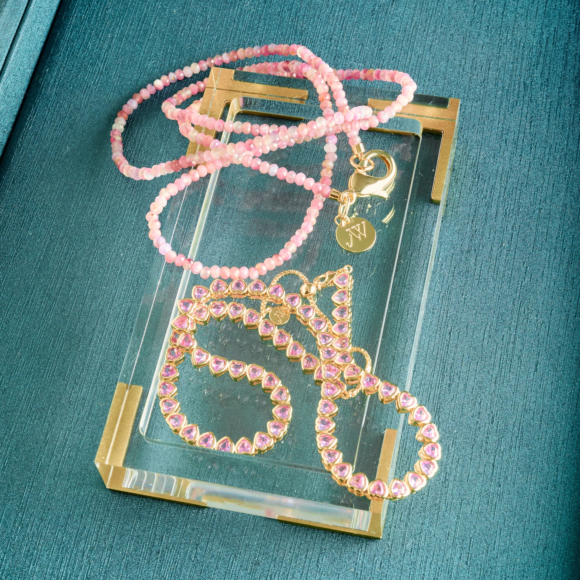 Stylized shot featuring the made from love tennis necklace and pink tourmaline double wrap 