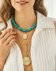 Model wearing various lucky pendants and the stone collector beaded necklace in turquoise