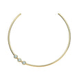 Gold neck cuff features three bezel set white CZ stones that sit off center