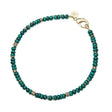 Beaded necklace featuring malachite beads with flat gold beads interspersed.  Necklace features oversized gold lobster clasp.