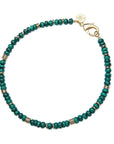 Beaded necklace featuring malachite beads with flat gold beads interspersed.  Necklace features oversized gold lobster clasp.
