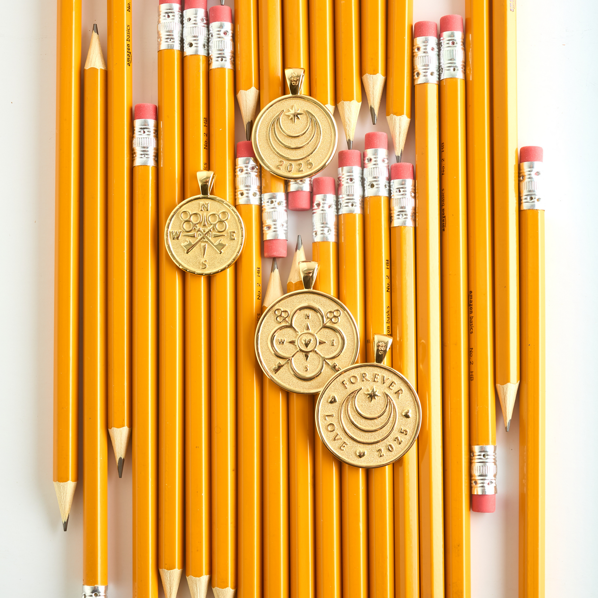 Stylized shot of gold forever 2025 coins with pencils