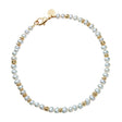 Freshwater pearl beaded necklace with flat gold beads interspersed, and oversized gold lobster clasp