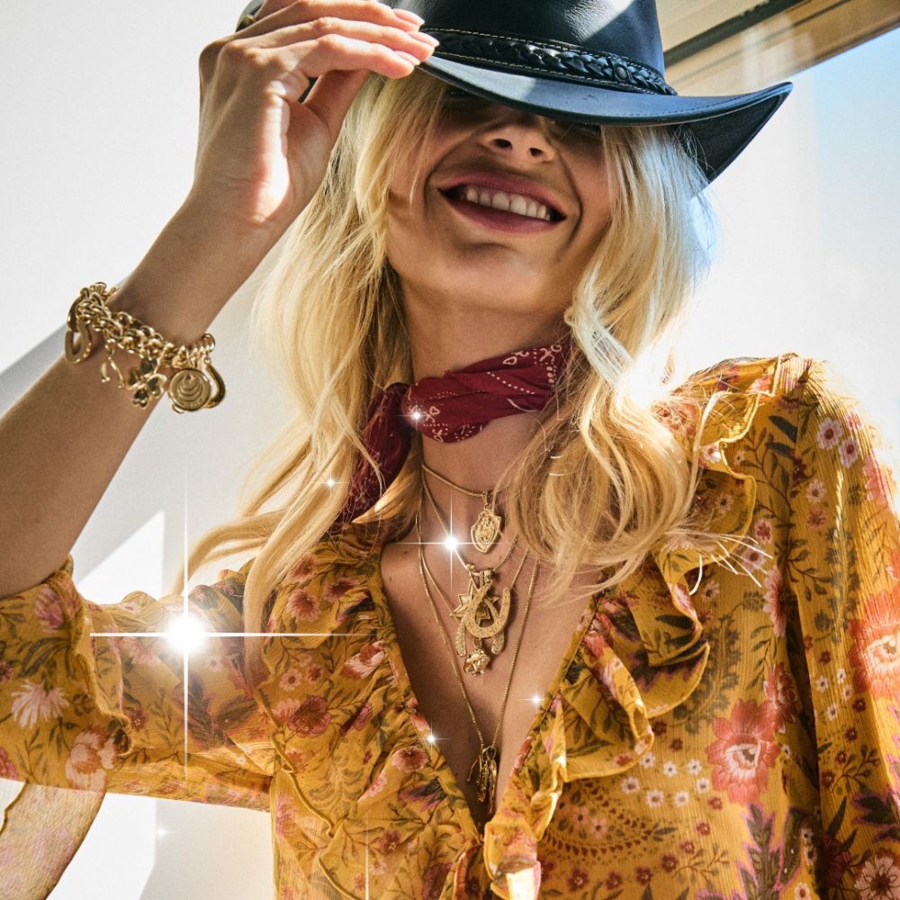 Jane Win model wearing a cowboy hat and multiple pendant necklaces