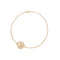 Delicate gold bracelet featuring tiny coin with morning glory design