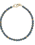 Round black pearl beads with flat gold beads interspersed and gold lobster clasp