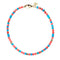 Beaded necklace with mix of turquoise and coral beads with flat gold beads interspersed. Necklace features oversized gold lobster clasp