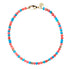 Beaded necklace with mix of turquoise and coral beads with flat gold beads interspersed. Necklace features oversized gold lobster clasp