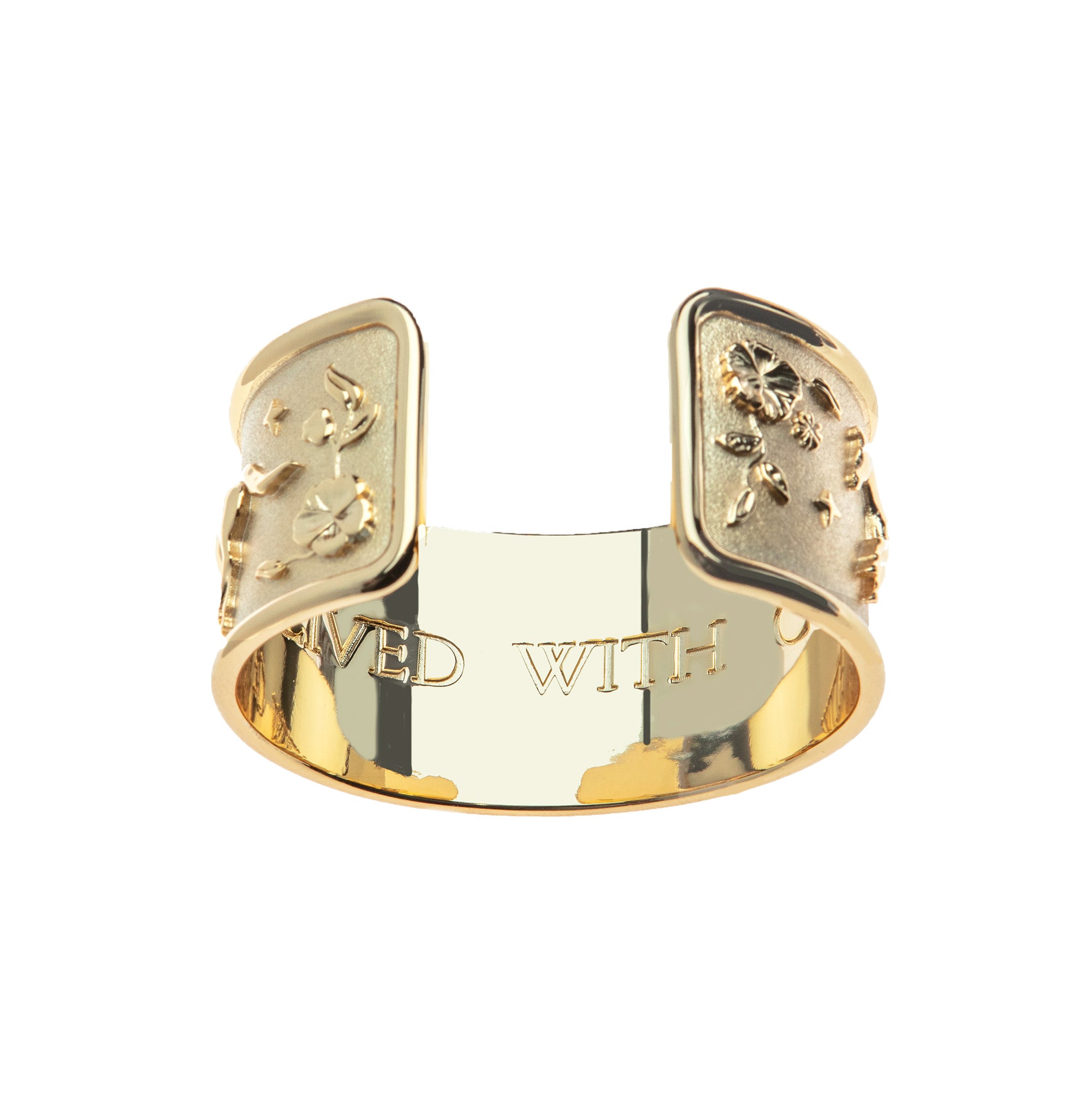 Inside of gold cuff bracelet features the phrase "A LIFE LIVED WITH COURAGE"