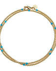 Beaded double wrap necklace features gold beads with a few pops of turquoise beads throughout