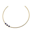 Gold neck cuff with three lapis cabochons sitting off center