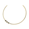 Gold neck cuff featuring 3 black mother of pearl cabochons that sit off center