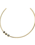 Gold neck cuff featuring 3 black mother of pearl cabochons that sit off center