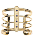 Gold open frame cuff features moon phases design with lapis accents