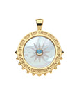 Carved mother of pearl sundial pendant with London blue topaz center stone. Pendant features gold edge that features roman numerals