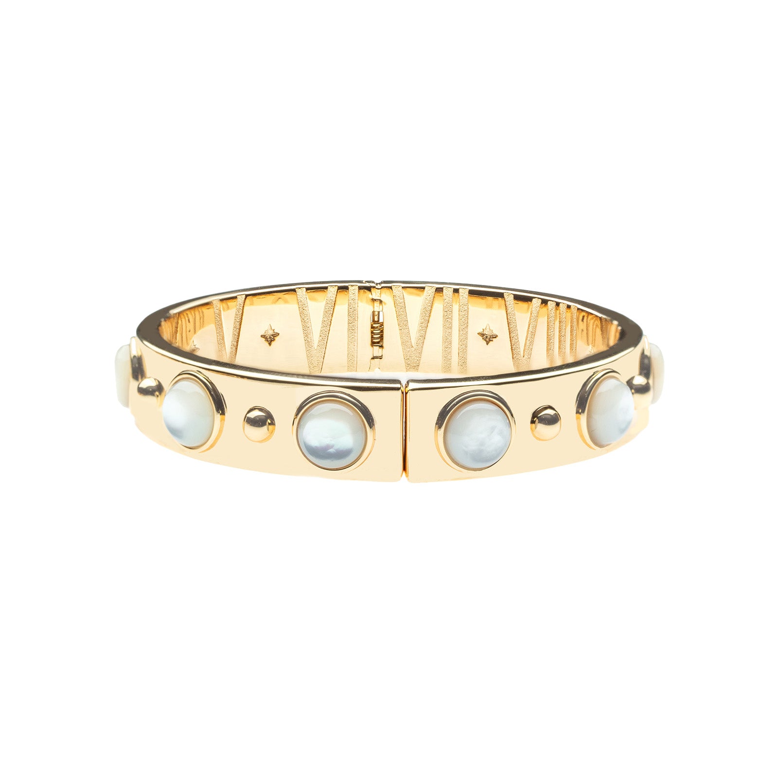 Gold hinge cuff bracelet features large mother of pearl cabochons on the outside, and then roman numerals with star details inside