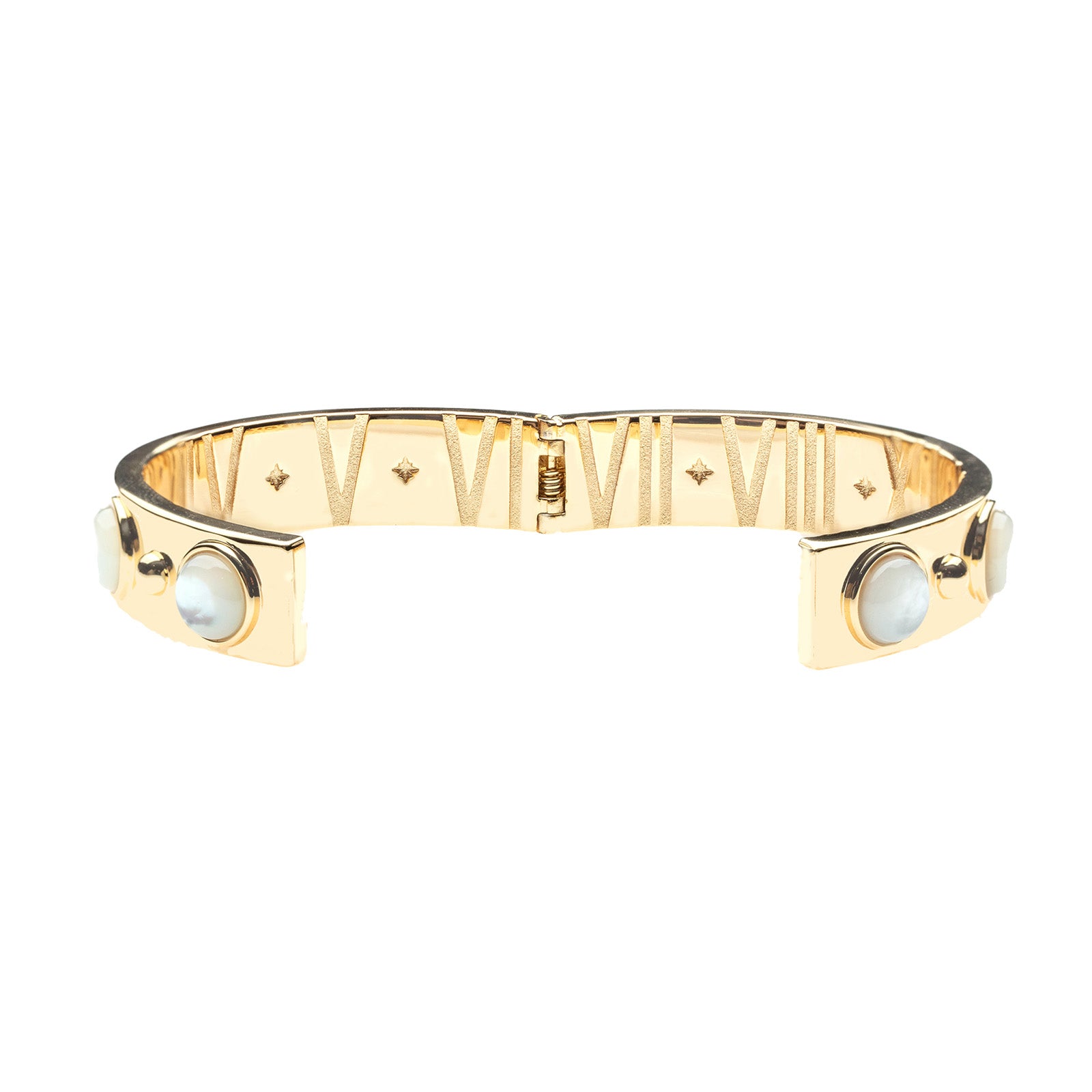 View of hinged cuff open to show roman numerals and star details inside 