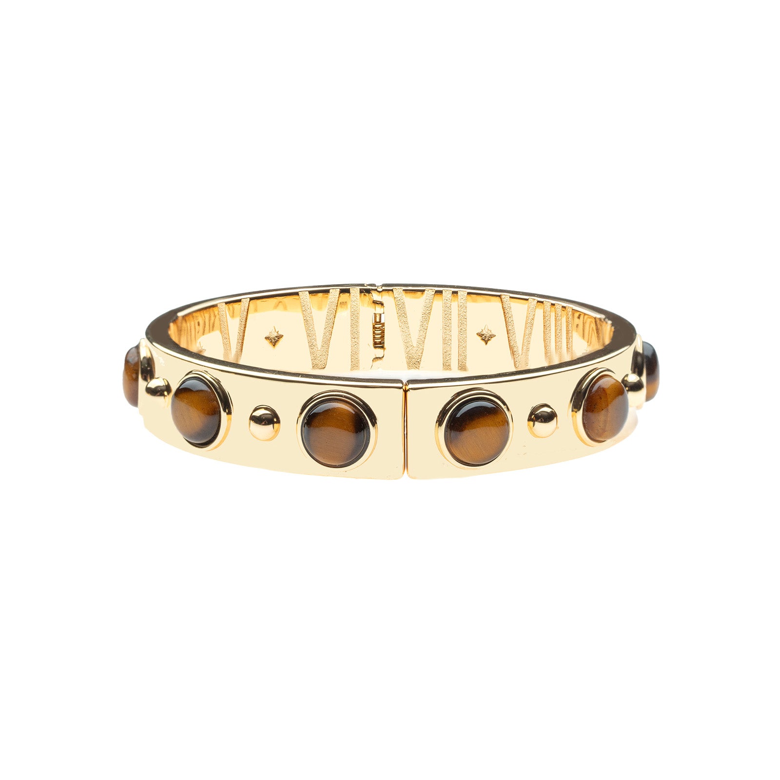 Gold hinged cuff bracelet featuring tiger's eye cabochons on the outside and roman numerals with star details on the inside.