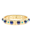 Gold hinge cuff bracelet features large lapis cabochons and small turquoise ones on the outside, and then roman numerals with star details inside