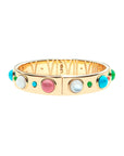 Gold hinged cuff features cabochon stones around the outside of Mother of Pearl, Green Jade, Coral, and Turquoise. Inside of cuff features roman numerals for 1-12