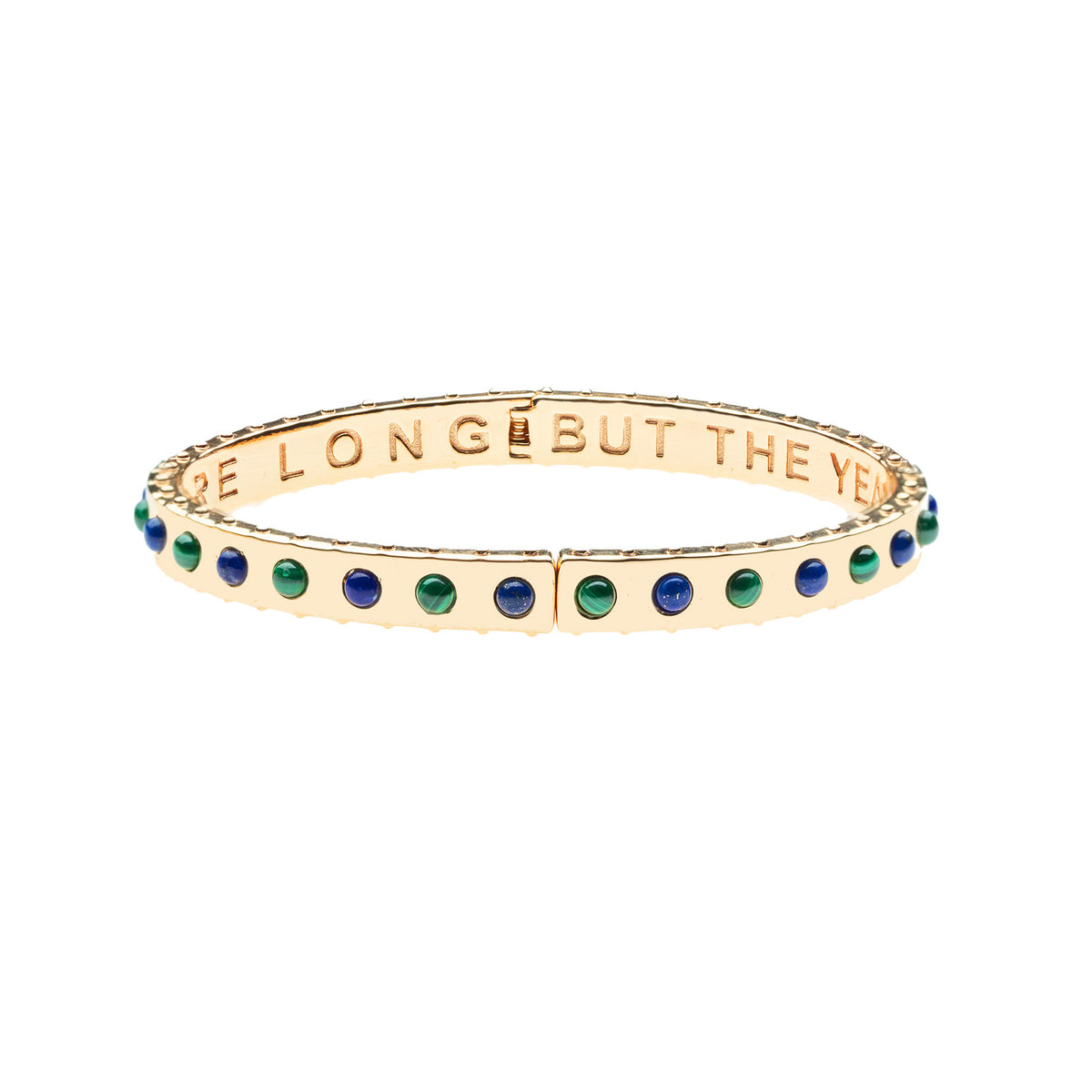 Thin gold hinge cuff features lapis and malachite stones on the outside and the phrase "the days are long but the years are short" inscribed on the inside