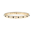 Thin gold hinge cuff features onyx and mother of pearl stones on the outside and the phrase "the days are long but the years are short" inscribed on the inside