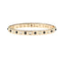 Thin gold hinge cuff features onyx and mother of pearl stones on the outside and the phrase "the days are long but the years are short" inscribed on the inside