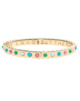 Thin gold hinge cuff features cabochons of Mother of Pearl, Green Jade, Coral, and Turquoises stones on the outside and the phrase "the days are long but the years are short" inscribed on the inside