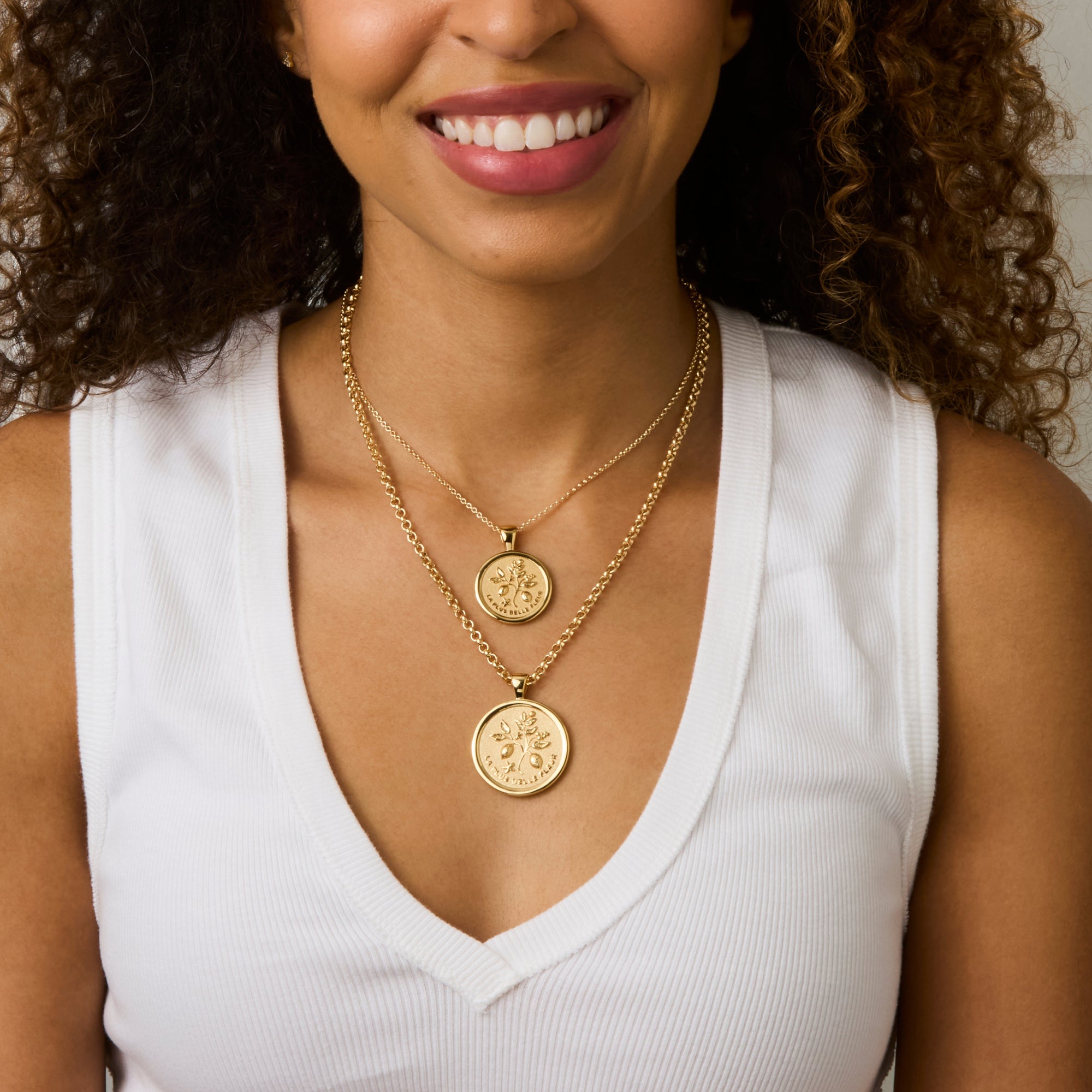 Model wearing the gratitude original coin on the grande rolo chain and the gratitude small coin on the classic rolo chain
