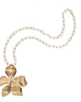 Gold periwinkle flower pendant on drawn link chain