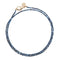Beaded necklace of kyanite beads (shades of blue) with oversized gold clasp