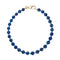 Beaded necklace features large carved lapis beads with small turquoise beads in between. Necklace has oversized gold lobster clasp