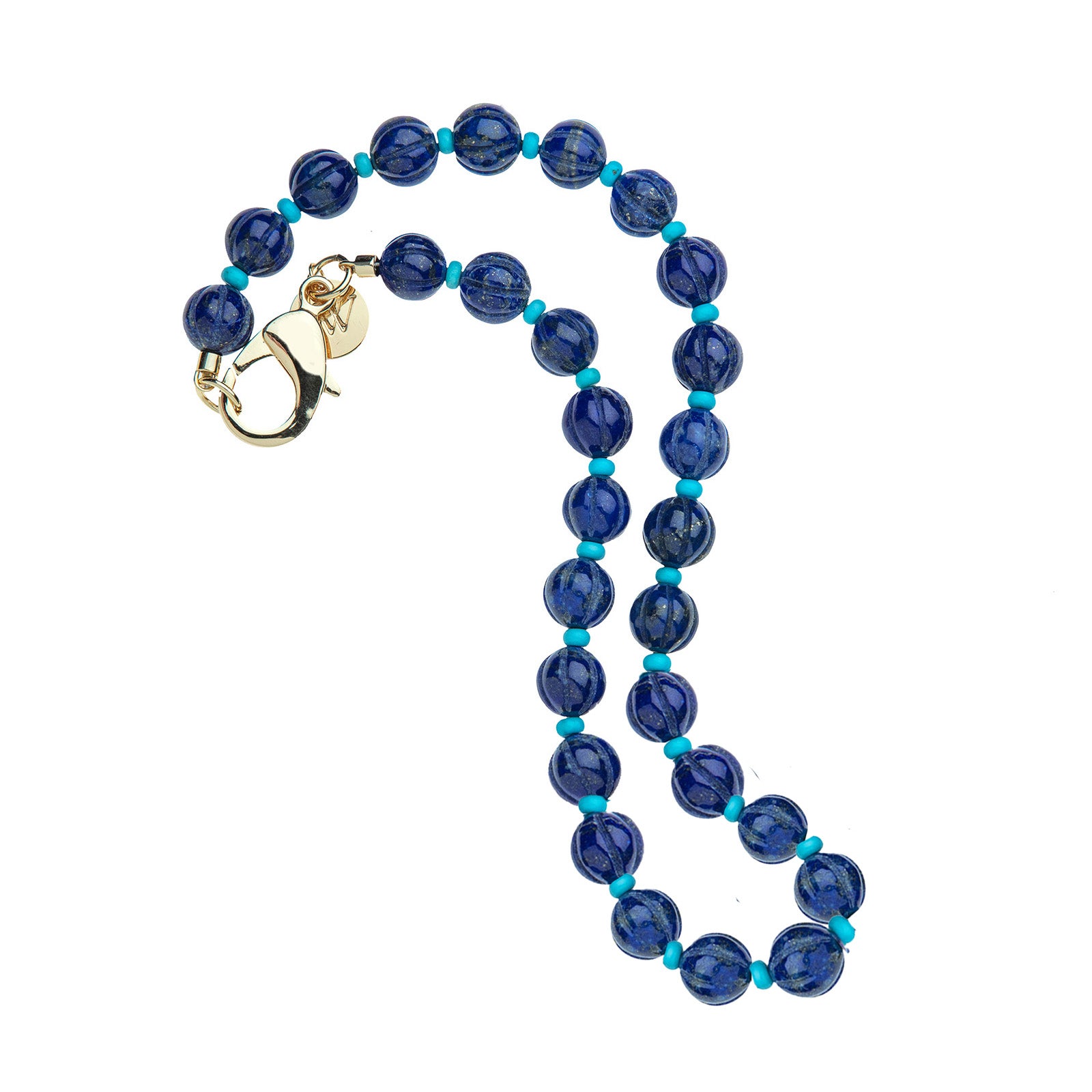 Beaded necklace features large carved lapis beads with small turquoise beads in between. Necklace has oversized gold lobster clasp