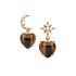 Drop earrings feature tiger's eye heart drop and mismatched star and crescent moon studs with mother of pearl cabochon details
