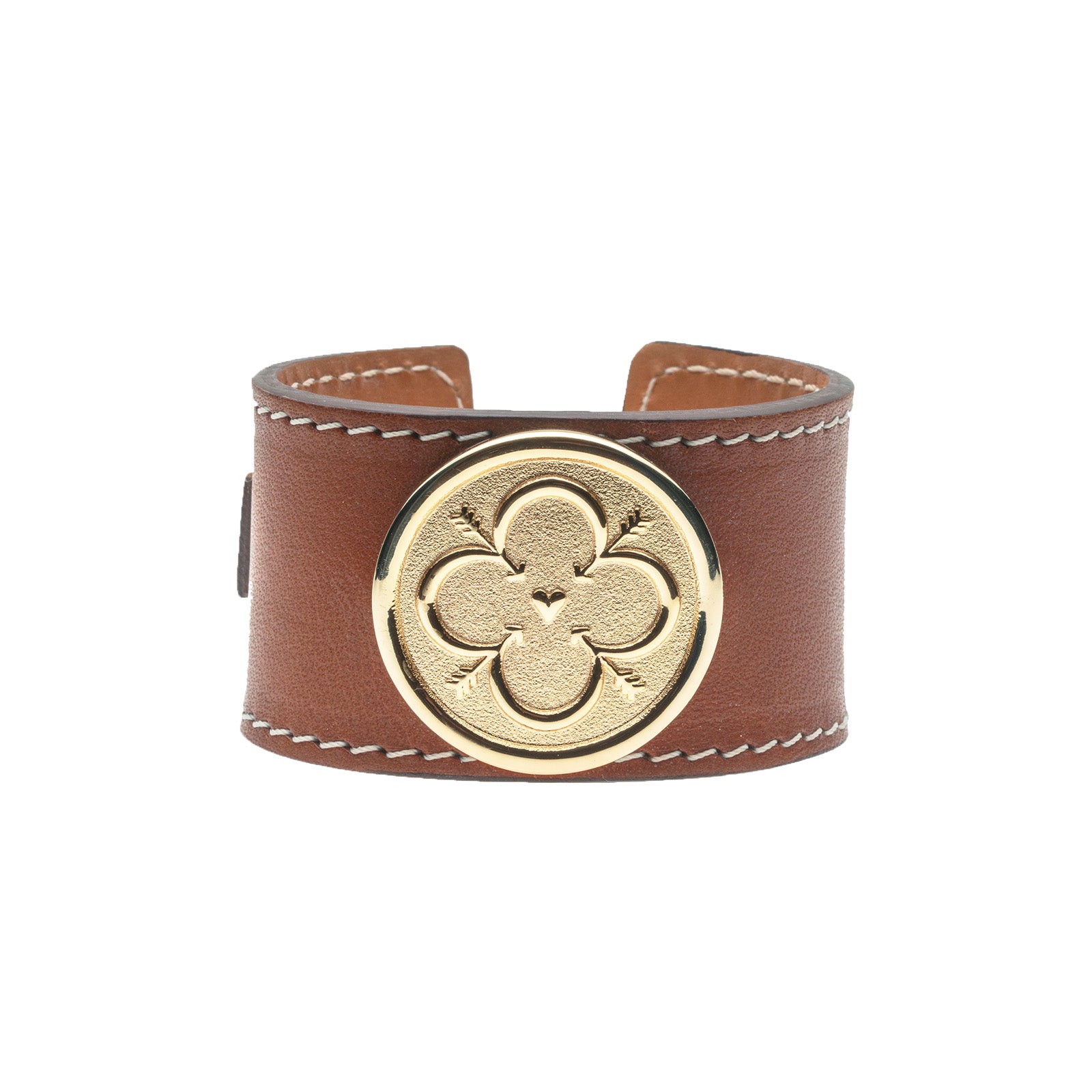 Brown leather cuff with white stitching features gold love coin in the center