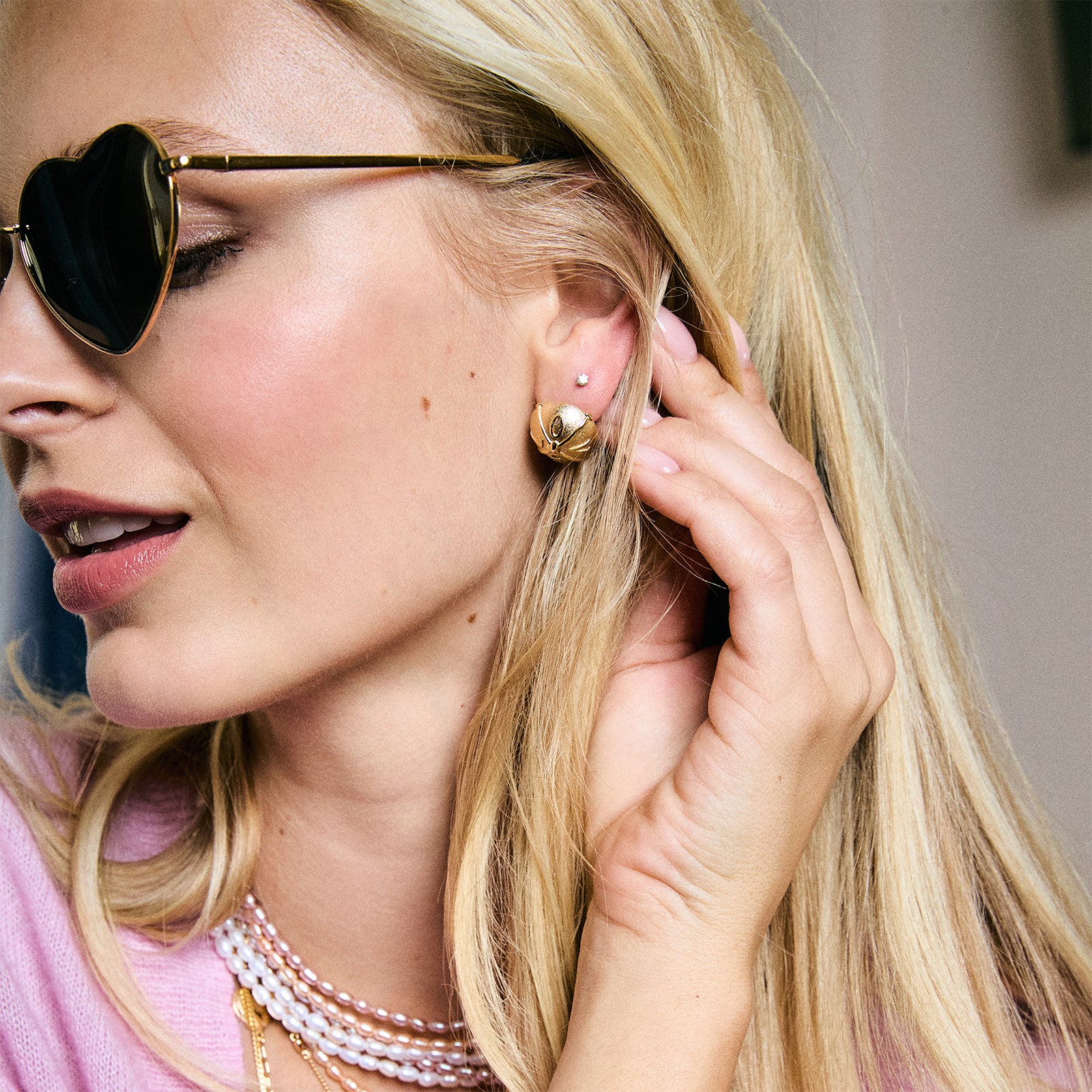 Model wearing the love button studs