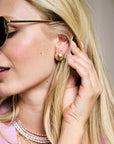 Model wearing the love button studs