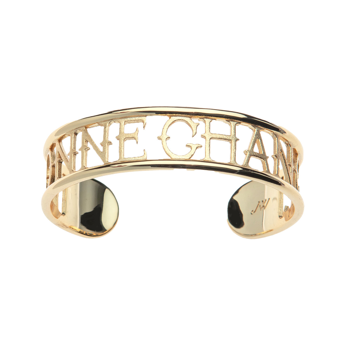 Gold cuff bracelet with cutouts around the words BONNE CHANCE