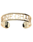 Gold cuff bracelet with cutouts around the words BONNE CHANCE