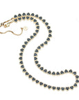 Gold tennis necklace features heart shaped black CZ stones