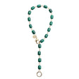 Necklace features chunky malachite beads with oversize gold lobster clasp and ring to attach pendants. Shown as a lariat.