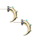 Side view of gold tusk inspired hoops. Hoops feature lapis cabochons at the base and turquoise cabochons along the hoop.
